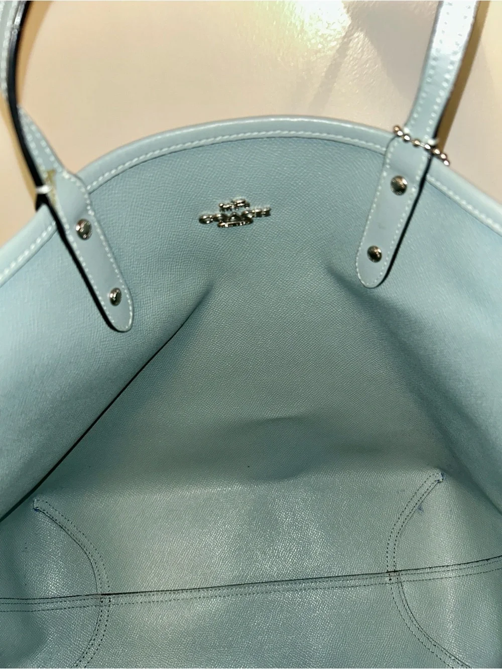 Coach feature approximately textured